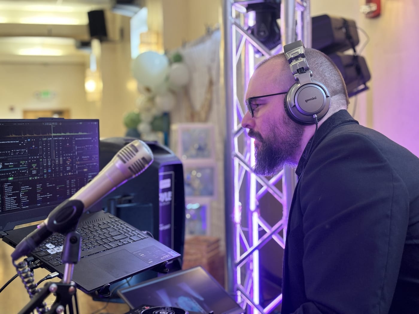 MixMaster Jack DJing at an event with purple stage lighting