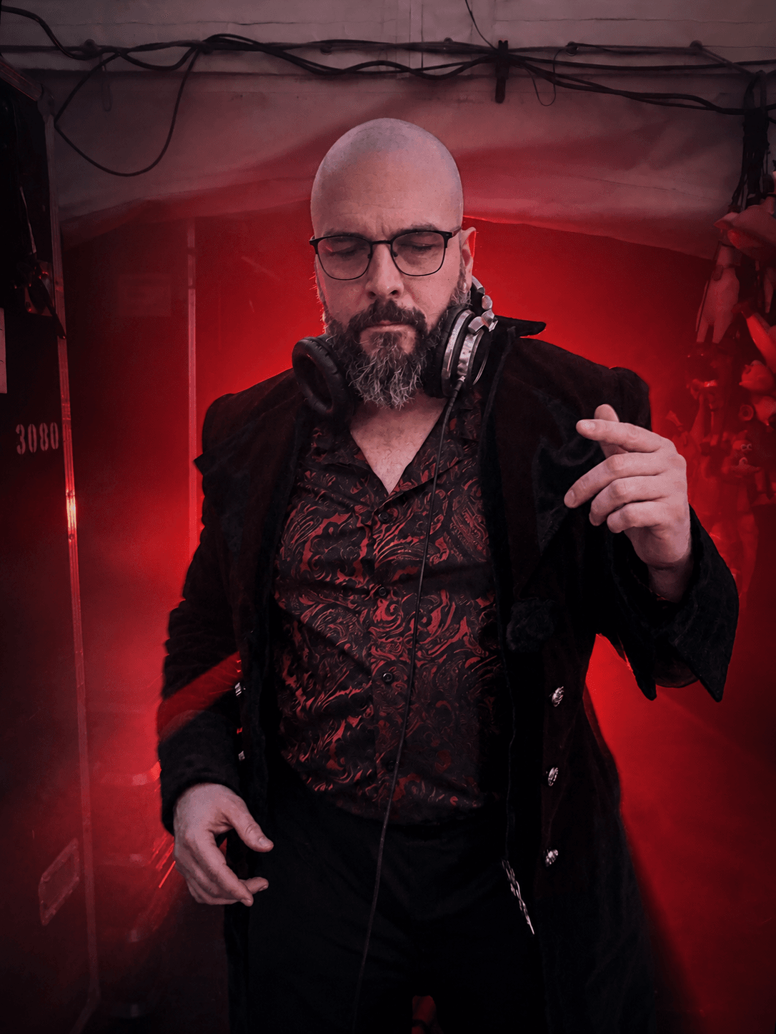 MixMaster Jack in a red and black velvet coat under dramatic red lighting